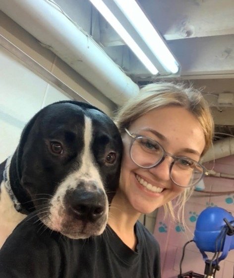 Anna C. in the grooming salon with a happy black and white dog